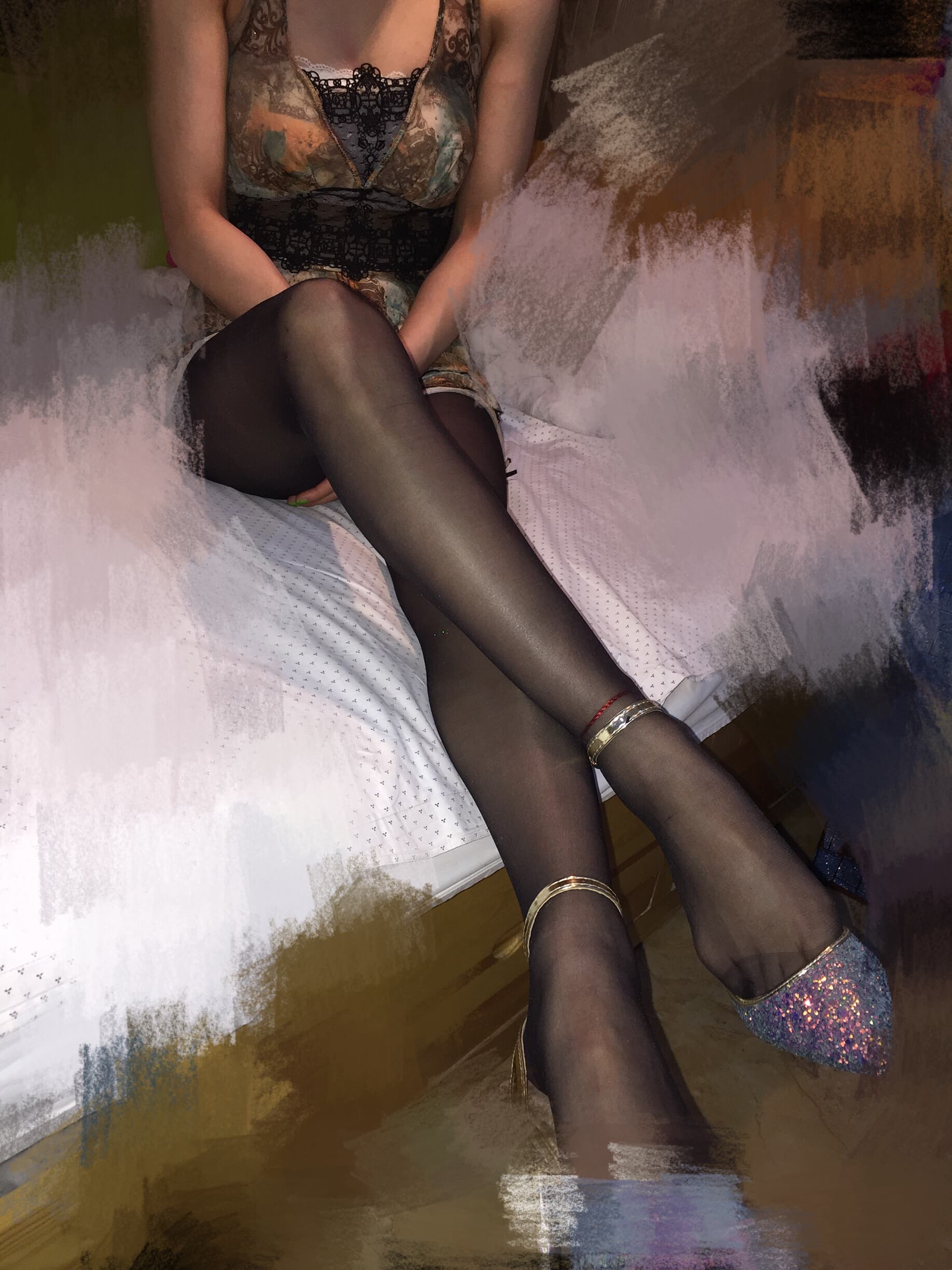 Soft-lit image of a desk-side outfit with sheer stockings and bare toes peeking from slippers, evoking casual, intimate routine.